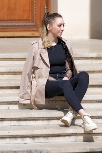 Young girl sitting on a building stairs